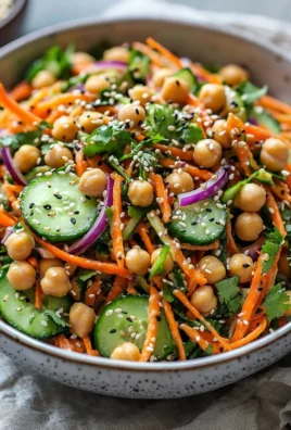 Asian cucumber and chickpea slaw with sesame dressing in a bowl