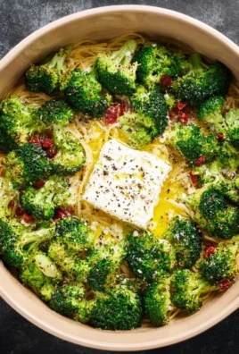 Baked Feta Pasta with broccoli in a creamy sauce served in a bowl.