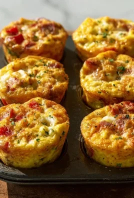 Delicious breakfast egg muffins served on a plate with fresh herbs