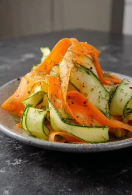 Colorful Carrot & Cucumber Ribbon Salad served in a bowl, highlighting fresh ingredients.