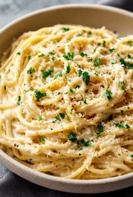 Delicious garlic parmesan spaghetti garnished with parsley and grated cheese