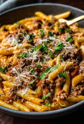 Delicious creamy beef pasta topped with herbs in a bowl