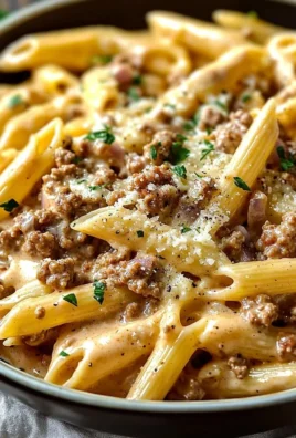 Plate of creamy beef pasta garnished with herbs