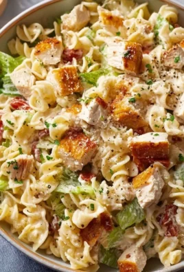 Creamy chicken pasta salad with vegetables in a bowl