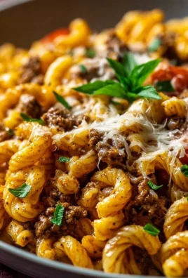 Creamy high protein beef pasta dish garnished with herbs