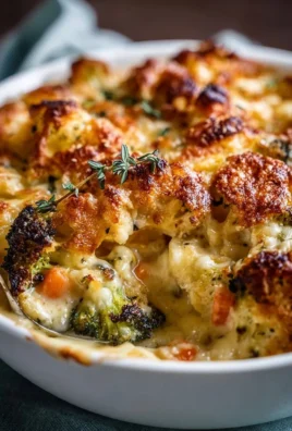 Creamy winter vegetable casserole topped with cheese and herbs