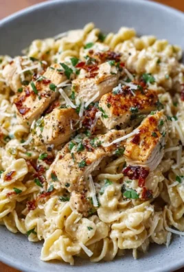 Crockpot Garlic Parmesan Chicken Pasta in a creamy sauce with herbs