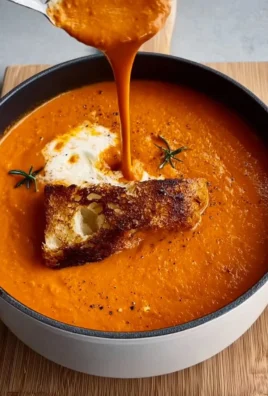 Easiest tomato soup garnished with basil leaves in a white bowl