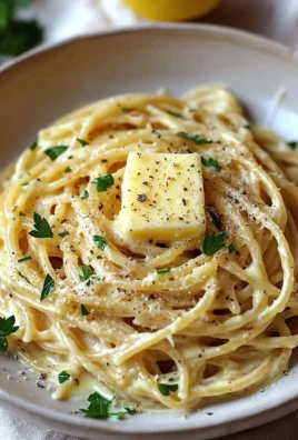 Creamy lemon garlic sauce on pasta garnished with herbs