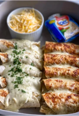 Creamy white chicken enchiladas topped with cheese and cilantro