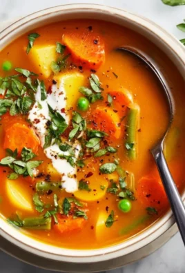 Bowl of easy vegetable soup with carrots, celery, and tomatoes
