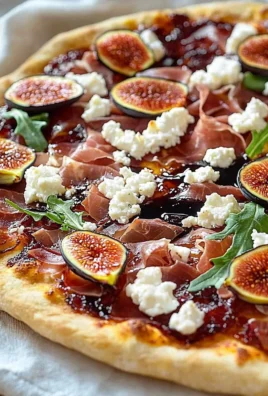 Fast fig pizza topped with goat cheese and prosciutto on a wooden board.