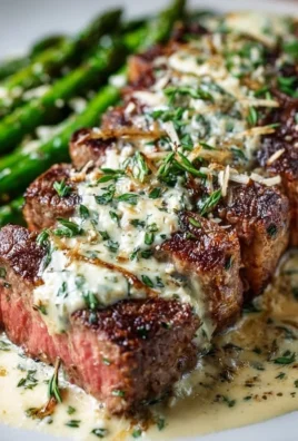 Garlic Butter Steak topped with Parmesan Cream Sauce served on a plate