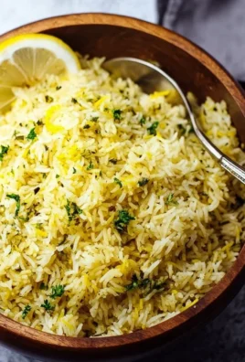 Bowl of Greek Lemon Rice garnished with fresh herbs