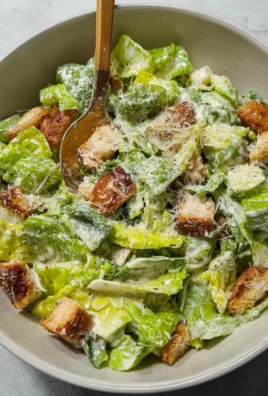 Bowl of homemade Caesar salad dressing with fresh ingredients