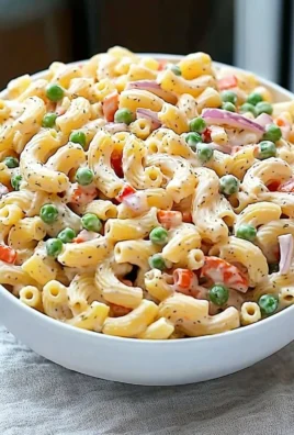 Classic macaroni salad with vegetables and dressing served in a bowl