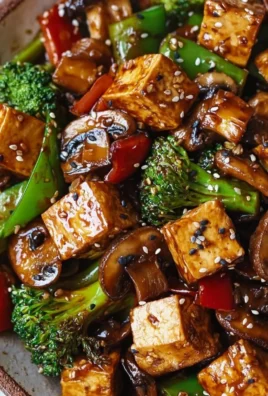 Delicious Mushroom and Tofu Stir-Fry on a plate with colorful vegetables