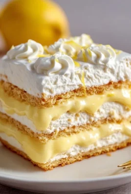 No-Bake Lemon Éclair Cake with whipped cream and lemon garnish