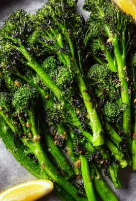 Plate of golden roasted broccolini, garnished and ready to serve.