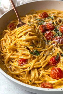 Roasted tomato and garlic ricotta pasta topped with fresh herbs and cheese.