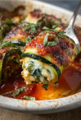 Zucchini Rollatini with cheese filling and marinara sauce on a plate