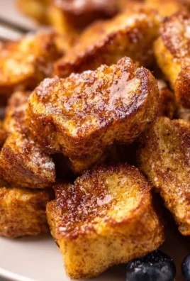 Air Fryer French Toast Bites served with syrup and berries