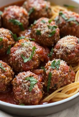 Baked Italian meatballs served with marinara sauce and spaghetti