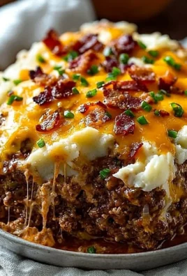 Delicious Cheesy Loaded Meatloaf Casserole topped with melted cheese and herbs