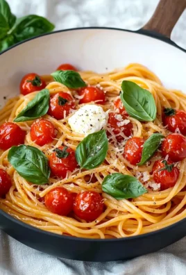Bowl of cherry tomato pasta with fresh basil and parmesan cheese
