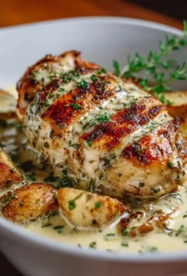 Creamy herb chicken dish garnished with fresh herbs