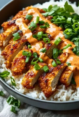 Crispy chicken with creamy spicy sauce served on jasmine rice