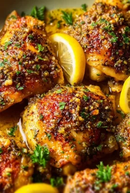 Crockpot lemon garlic chicken served with herbs and lemon slices