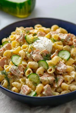 Dill Pickle Tuna Pasta Salad in a bowl with fresh herbs and vegetables