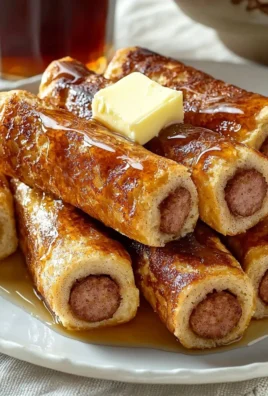 Delicious French Toast Roll-Ups served on a plate with syrup and berries