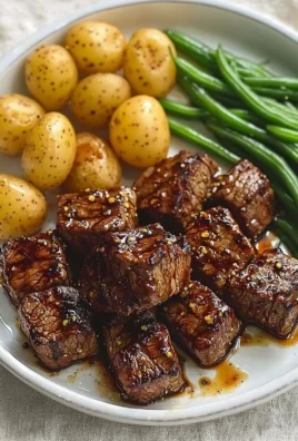 Garlic balsamic steak bites served on a plate with garnishes