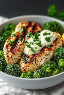 Healthy grilled chicken bowls with broccoli and creamy garlic sauce