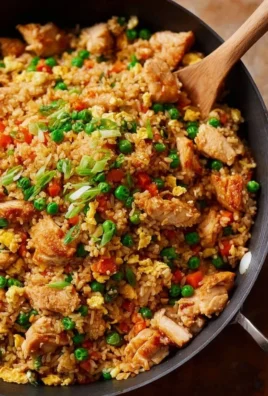 High Protein Chicken Fried Rice served in a bowl with colorful vegetables