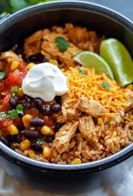 Instant Pot chicken burrito bowls with toppings and ingredients on a wooden table