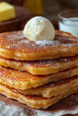 Delicious Spanish churro pancakes topped with chocolate sauce and cinnamon sugar.