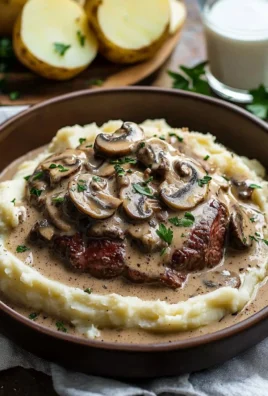 Juicy meat served with creamy mushroom sauce, showcasing rich flavors and textures.