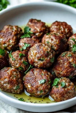 Delicious Keto Greek Meatballs (Keftedes) served with fresh herbs and sauce