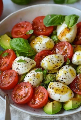 Light and colorful avocado caprese salad with tomatoes and mozzarella