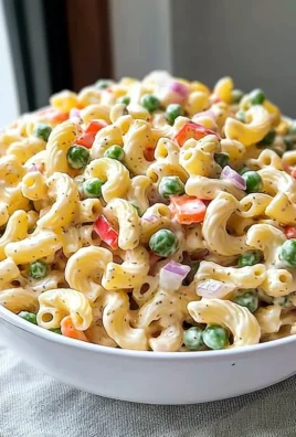 Delicious homemade macaroni salad served in a bowl with fresh vegetables