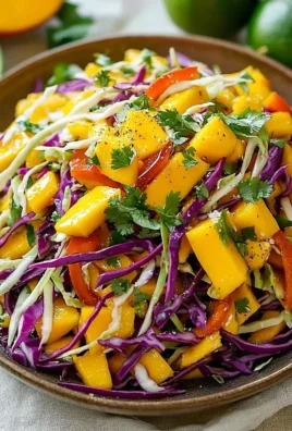 Colorful mango slaw garnished with cilantro served in a bowl