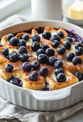 Delicious Blueberry French Toast Casserole topped with fresh blueberries and syrup.