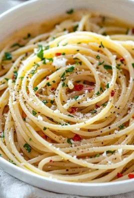 Plate of spaghetti with garlic and oil garnished with parsley