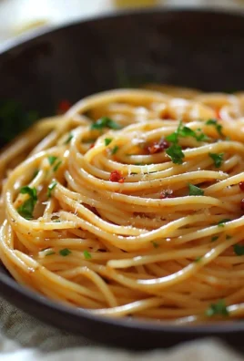 Delicious spicy spaghetti pasta garnished with herbs and chili flakes