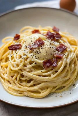 Creamy spaghetti carbonara served in a bowl with garnish