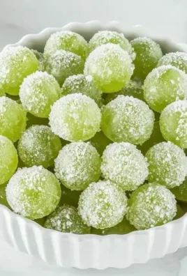 Bowl of 3-ingredient sour candied frozen grapes resembling Sour Patch Kids