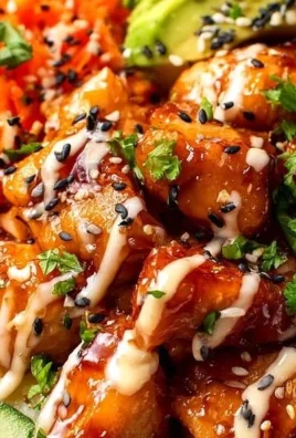 A vibrant Bang Bang Chicken bowl topped with fresh vegetables and spicy sauce